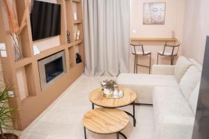 a living room with a couch and a table at Kostis Luxury Apartment in Agrinio