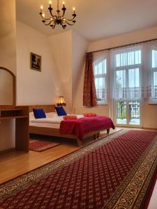- une chambre avec un lit et une grande fenêtre dans l'établissement Pałacyk Srebrna Fala, à Międzyzdroje