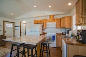 a kitchen with wooden cabinets and a island with bar stools at Couer d'Alene Charm in Coeur d'Alene