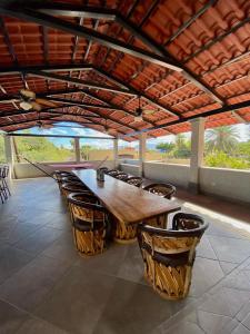 a large wooden table and chairs under a roof at Studio Candelero en Loreto in Loreto