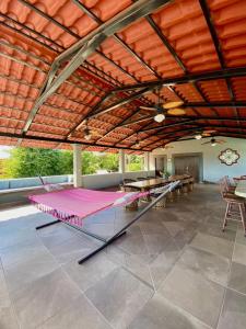 a large patio with tables and a large roof at Studio Candelero en Loreto in Loreto