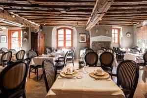 a restaurant with tables and chairs in a room at Canal View Hotel Ter Brughe by CW Hotel Collection in Bruges