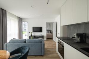 a living room with a blue couch in a kitchen at No. 1 PARK AVENUE APARTMENT in Kaunas
