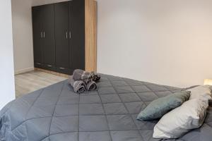 a bedroom with a large gray bed with a black cabinet at ACC Vergara opción de Parking in Jaén