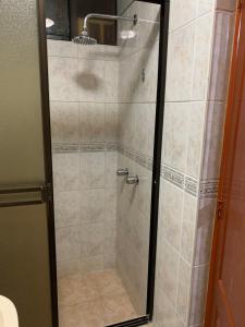 a shower with a glass door in a bathroom at Grand Hotel Betsy in Lima