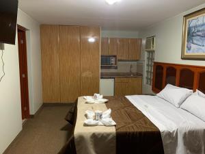 a bedroom with a large bed with towels on it at Grand Hotel Betsy in Lima