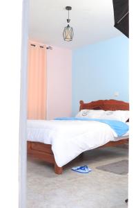 a bedroom with two beds and a pair of flip flops at Koma Gardens and Resort in Nguluni