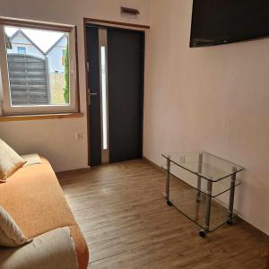 a room with a glass table and a window at Olimp Resort in Sarbinowo