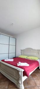 a bedroom with a bed with a red blanket at Residenza Gaia in Ispra
