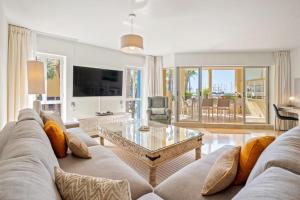 a living room with a couch and a table at Vista Marina - Puerto Sotogrande in Sotogrande