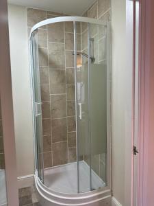 a shower with a glass door in a bathroom at Castle View, 96 Friar Lane in Nottingham