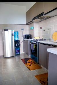 a kitchen with a stainless steel refrigerator and a stove at Indesign makumbi park Elegant 2 bedrooms in Nairobi