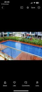 a picture of a swimming pool in front of a building at Indesign makumbi park Elegant 2 bedrooms in Nairobi