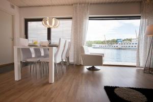 a dining room with a table and chairs and a large window at SResort Marina Villas in Imatra