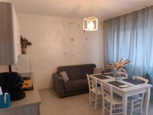 a living room with a table and a couch at Sweety House in San Giovanni Gemini