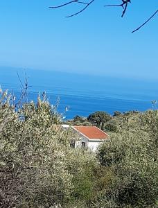 a house on a hill with the ocean in the background at Skyline 360 Estate A secluded retreat stunning sea and mountain views in Caccamo