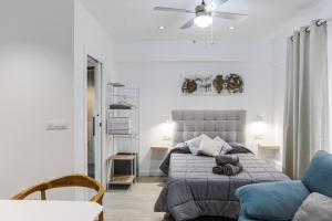 ein Schlafzimmer mit einem Bett und einem blauen Sofa in der Unterkunft ACC Vergara 2 opción de Parking in Jaén