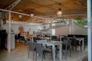 a group of people sitting at tables in a restaurant at Seawood beach front resort in Morjim