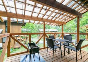 a patio with a table and chairs on a deck at Farm Inn Neba - Vacation STAY 46696v in Urugi