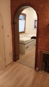 a mirror in a room with a bed in a bedroom at Apartment Messe Hannover in Garbsen