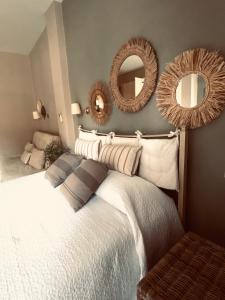 a bedroom with a bed with mirrors on the wall at Las plantas-studios-apartments-Corfu in Dassia
