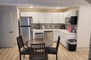 a kitchen with a table and chairs and a refrigerator at The Hamilton House Loft in Omaha