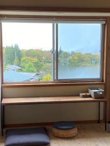 a window sill with a bench in front of a window at Togaku Hokosha - Vacation STAY 15767 in Nagano