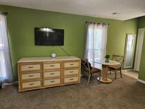 a living room with a television on a green wall at 6BR in Suburban area close to Freeway and Galeria in Memphis