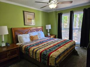a bedroom with a bed with green walls and a fan at 6BR in Suburban area close to Freeway and Galeria in Memphis