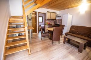 a room with a staircase and a living room at Family Keyhouse in Schitul