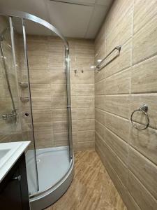 a bathroom with a shower and a sink at Premier Fort Apartment on Seafront in Sveti Vlas