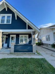 a blue house with a blue garage at The Hamilton House Family Home in Omaha