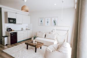 a white living room with a couch and a table at Edera Spa in Rueil-Malmaison