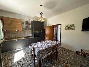 a kitchen with a table and a dining room at La lavanda in Controguerra