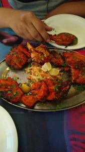 a plate of food on a table with food at Hotel Avenue Regency in Mumbai