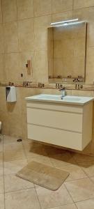 a bathroom with a sink and a mirror at Villa Chaplin in Tirana +82 photos