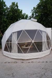 a white tent with a table inside of it at Sougia Glamping in Chania