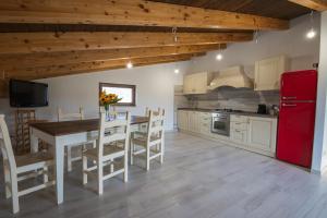 a kitchen with a table and a red refrigerator at Roberta House in Isernia