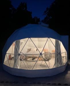 a tent with a table inside of it at night at Sougia Glamping in Chania Town