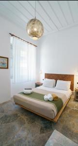 a bedroom with a large bed with two towels on it at Livin Hydra Private Collection Suite 1 in Hydra