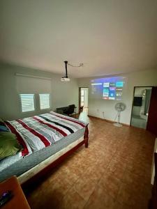 a bedroom with a bed and a television in it at Camino Al Cielo in Guayanilla