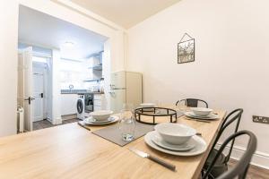 a dining room with a wooden table with chairs at Liverpool city centre house, Free parking in Liverpool