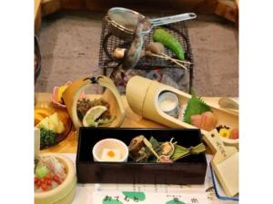 a table topped with a box of food on a table at Houraku - Vacation STAY 23297v in Kamikawa