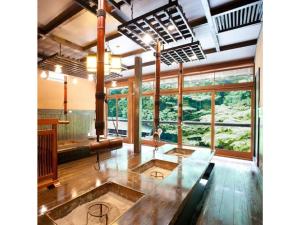 a large room with a glass table and large windows at Houraku - Vacation STAY 23297v in Kamikawa