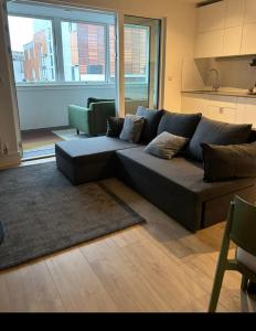 a living room with a couch and a kitchen at Wembley Park in London