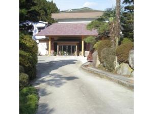 a road in front of a building with bushes at Houraku - Vacation STAY 23297v in Kamikawa