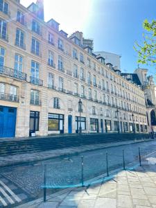 a large building on the side of a street at SAINT- PAUL - LUXURY APARTMENT IN HOTEL DE VILLE in Paris