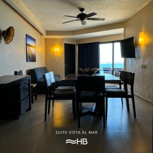 Hotel Barra de Navidad في بارا دي نافيداد: غرفة طعام وغرفة معيشة مع طاولة وكراسي