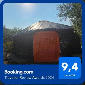 a black yurt with a wooden door in it at Yurta Bora Bora in L'Ametlla de Mar