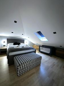 a bedroom with a bed and a flat screen tv at Plaza Apartments in Sarajevo